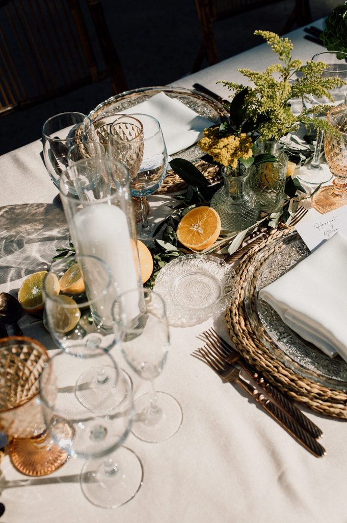 Elegant table setting with flowers and citrus slices.