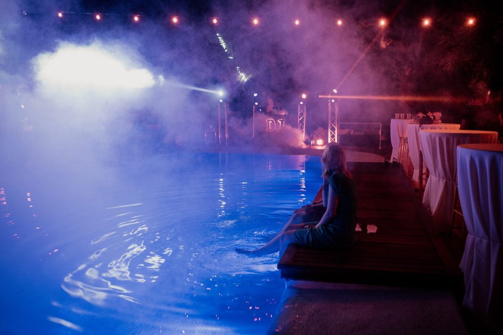 Guest enjoying the pool at their friend's wedding in a private villa 